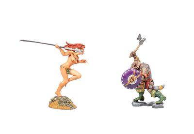 two figurines of a woman with a sword and a man with a shield