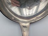 a reflection of a person in a mirror on a silver spoon