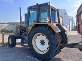 a tractor that is parked on the side of the road