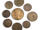 several coins are arranged in a circle on a white surface