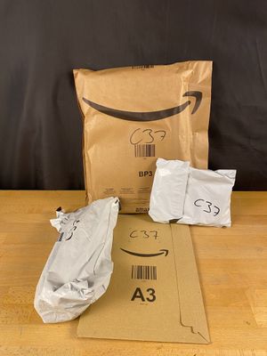 a brown bag with a smile on it sitting on a table next to a brown bag with a smile on it