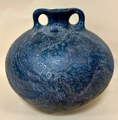 a blue vase that is sitting on a table