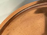 a close up of a pan with a shadow of a person on it