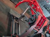 a gym with a red bench and a barbell on it