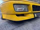 a close up of a yellow car with a license plate on it