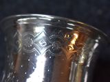 a silver vase that is sitting on a table