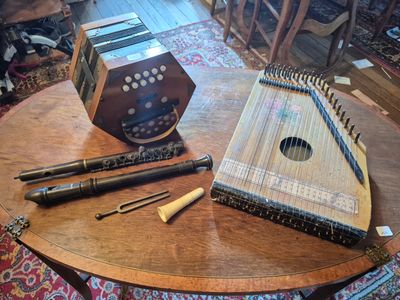 a table with a musical instrument and a pen on it