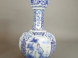 a blue and white vase sitting on a table