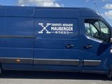 a blue van that is parked in a parking lot