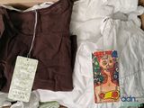 a box of clothes and a book on the floor