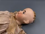a doll that is laying down on the floor