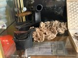a glass case with a bunch of items inside of it