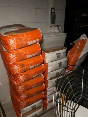 a stack of orange bags sitting on top of a stack of white boxes