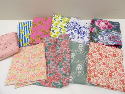 a bunch of different types of fabric on a table