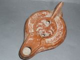 a clay animal head with a hole in the middle of it