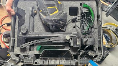 a man that is holding a tool in a case