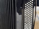 an image of a black accordion sitting on top of a wooden table