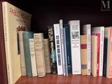 many books that are on a book shelf together