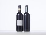 two bottles of wine sitting next to each other on a table