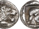 a close up of a silver coin with a head of a woman