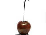 a sculpture of an apple on a block on a white background
