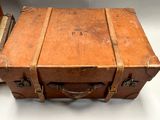 a brown suitcase sitting on a white table