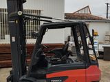 a red fork truck parked in front of a building