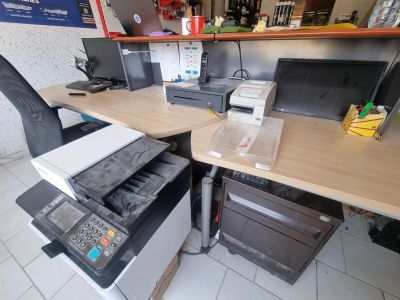 a computer desk with a printer and a printer on it