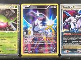 three different types of pokemon cards sitting on top of a table