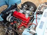 a blue car with a red engine and some black tires