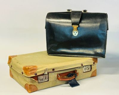 two suitcases sitting next to each other on a white surface