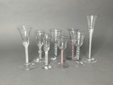 several wine glasses and a wine glass are lined up on a table