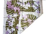a white and purple flowered handkerchief on a white background
