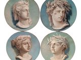 four plates with heads of men and women on them in blue and white