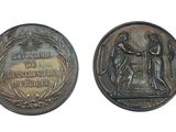 an old coin with a picture of a man and a woman on it