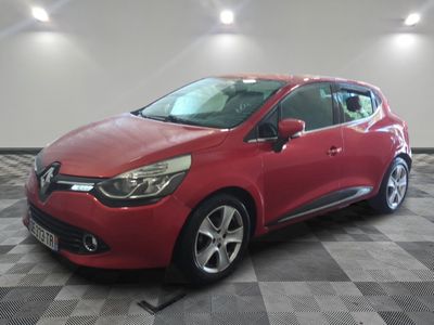 the red car is parked on a checkered floor in the garage
