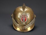 a gold helmet with a red emblem on it