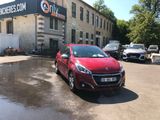 a small red car parked in front of a building