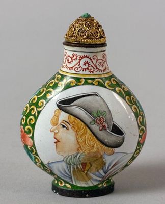 a small vase with a picture of a woman on it