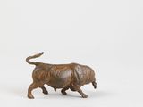 bronze figurine of a bull on a white background