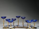 un ensemble de six bougeoirs en verre bleu et en laiton