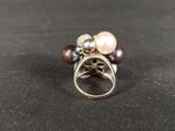 a close up of a ring with pearls and a star