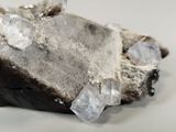 a piece of rock that has some crystals on top of it