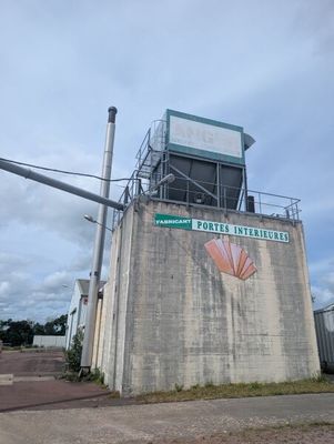 a cement building with a sign on the side of it