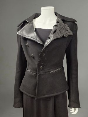 a black jacket and skirt suit with a leather collar on a mannequin mannequin mannequin mannequin mannequin mannequin manne
