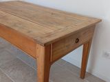 a wooden table with a drawer on top of it