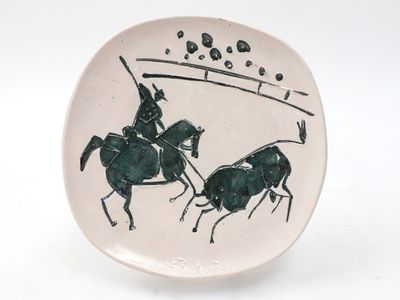 a plate with a picture of two men on horses