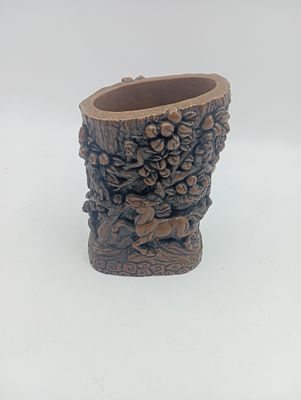 un petit vase orné d'un motif sculpté
