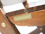 a close up of a wooden chair with a label on it