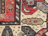 a close up of a rug with a red and blue design on it
